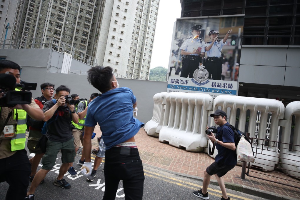 A protester throws eggs outside Tseung Kwan O Police Station. Photo: Winson Wong