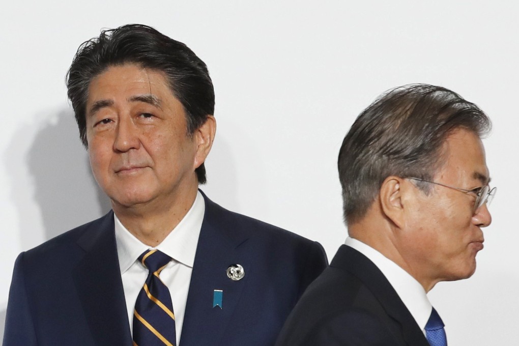 South Korean President Moon Jae-in (right) walks past Japanese Prime Minister Shinzo Abe at the G20 summit in Osaka in June. The last trilateral summit with China was held in Tokyo in May last year. Photo: Bloomberg