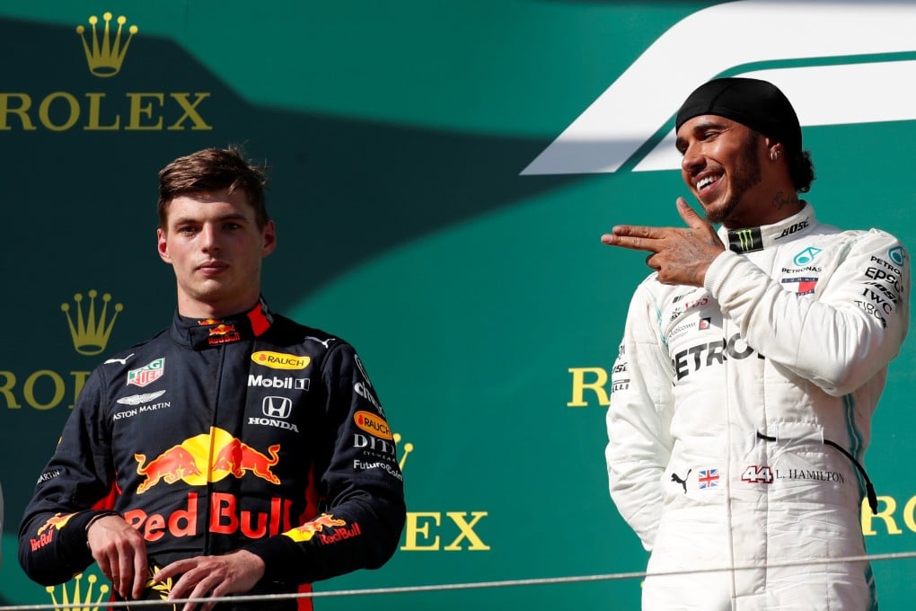 Mercedes’ Lewis Hamilton celebrates winning the Hungarian Grand Prix as Red Bull’s Max Verstappen looks on, on Sunday. Photo: Reuters