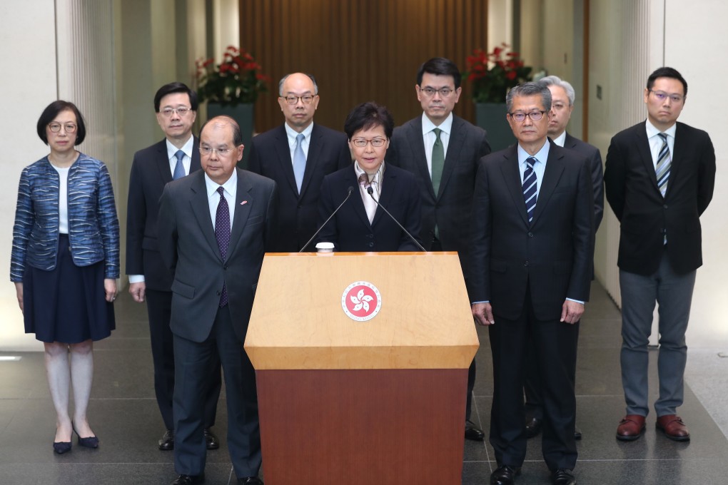 Chief Executive Carrie Lam, flanked by eight of her ministers, addresses the press in Tamar. Photo: Sam Tsang