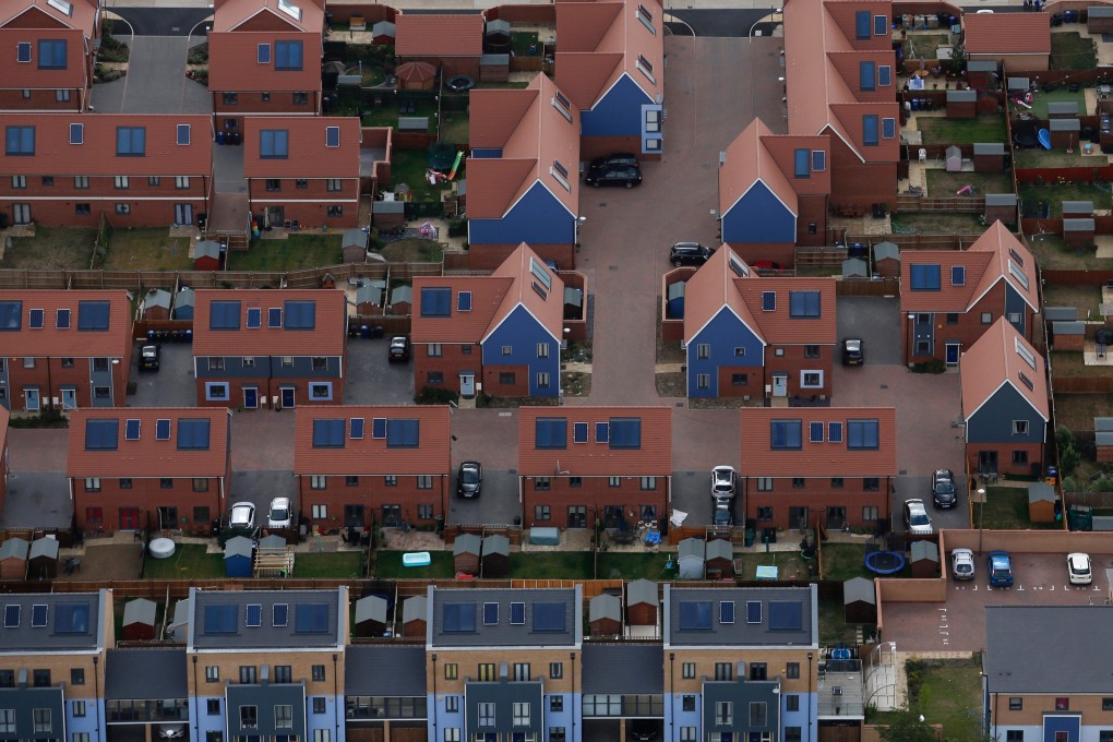 Residential homes under construction sit next to completed homes in this aerial photograph taken over Ashford, UK on July 22, 2015. Photo: Bloomberg