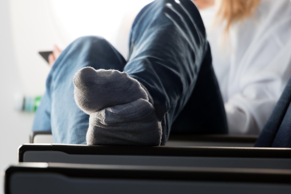 Seat belts off, feet up – but is a busy plane the best place to be making yourself feel at home? Photo: Alamy