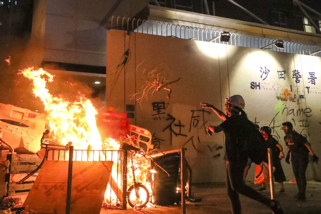 Protesters start a fire at Sha Tin Police Station. Photo: Felix Wong