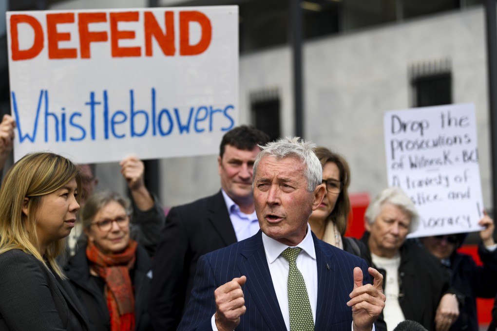 Bernard Collaery, right, the ex-spy’s former lawyer, addresses the media outside the court in Canberra. Photo: AP