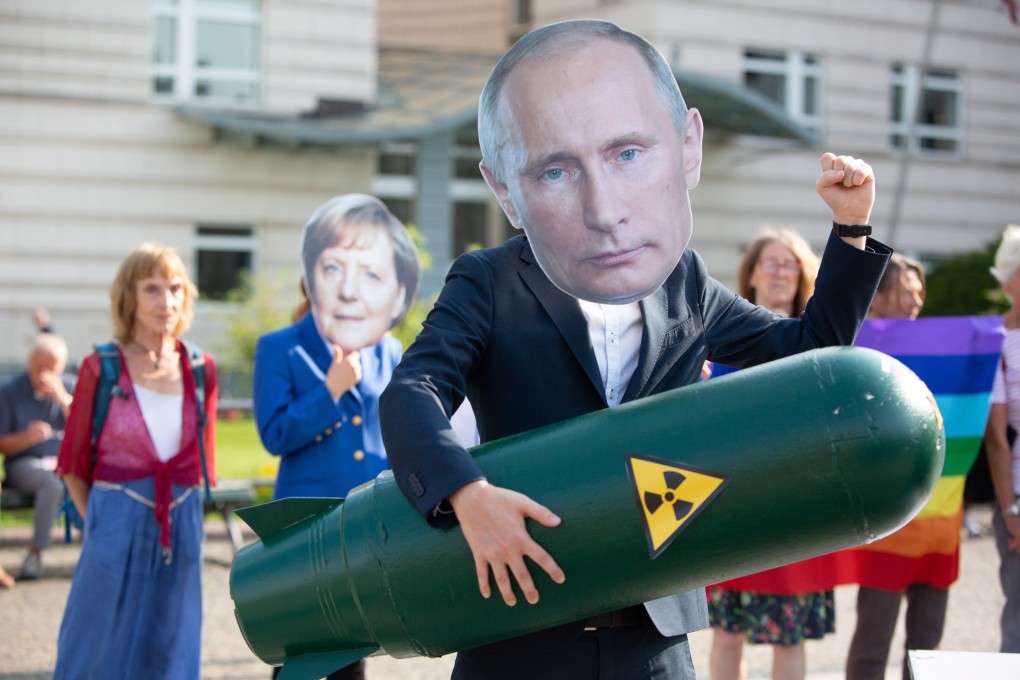 An activist wearing a Putin mask holds a mock missile at a protest in Berlin against the ending of the treaty. Photo: EPA