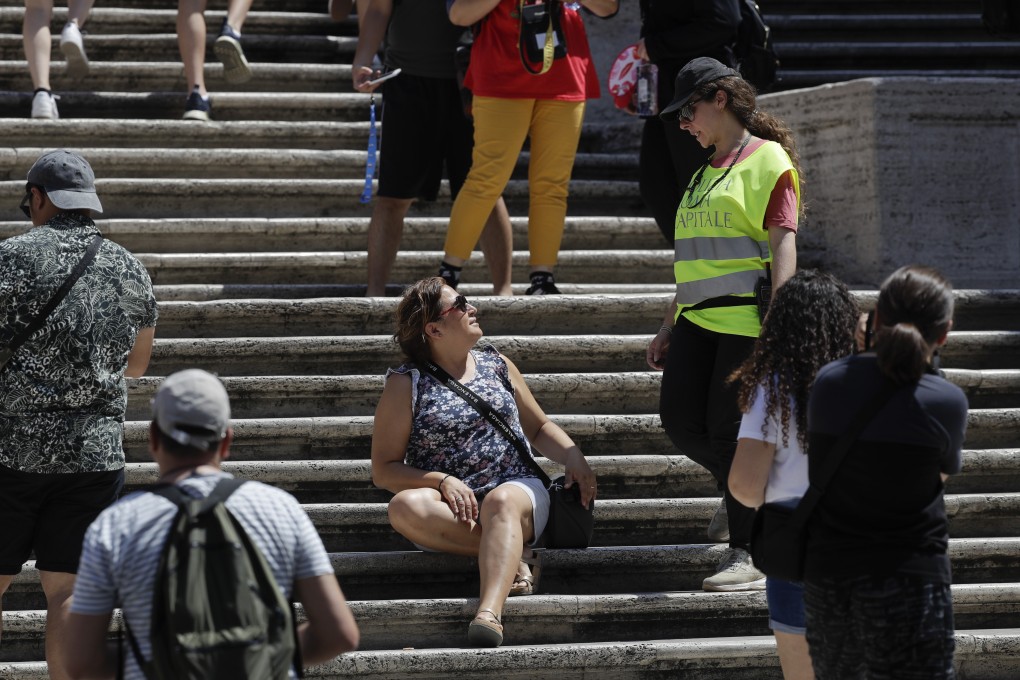 A police officer asks a woman not to sit on the Spanish Steps in Rome on Wednesday. Photo: AP