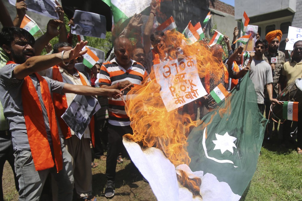 About a dozen activists of a Hindu group burn a Pakistani flag during a protest in Jammu, part of the larger region of Kashmir, on Thursday. Photo: AP