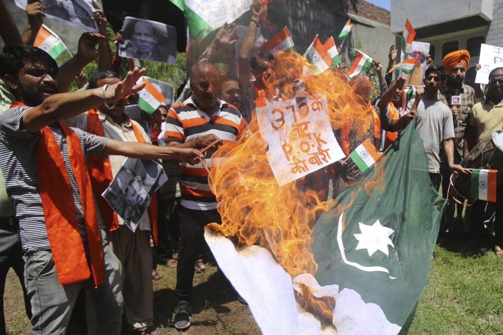 About a dozen activists of a Hindu group burn a Pakistani flag during a protest in Jammu, part of the larger region of Kashmir, on Thursday. Photo: AP