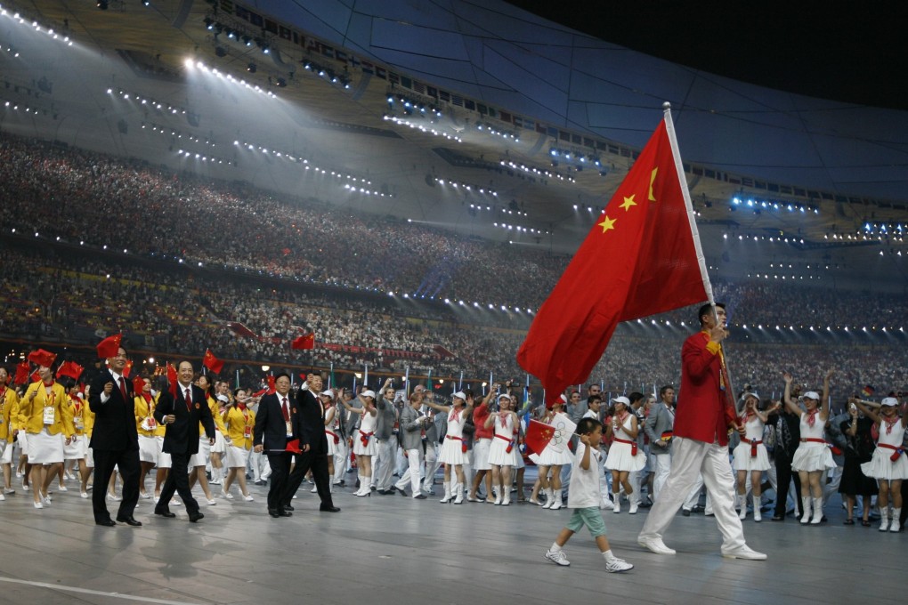 Yao Ming and earthquake survivor Lin Hao lead the opening ceremony of the Beijing 2008 Olympic Games at the National Stadium. Photo: Reuters