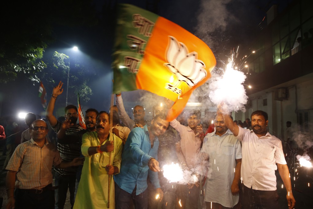 Supporters of India's ruling Bharatiya Janata Party (BJP) light firecrackers and celebrate the government revoking Kashmir's special status. Photo: AP