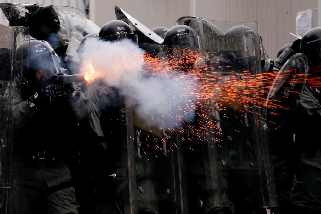 Police officers fire tear gas at demonstrators during a July 27 protest in Yuen Long against the July 21 gang attack in Yuen Long MTR station. Photo: Reuters