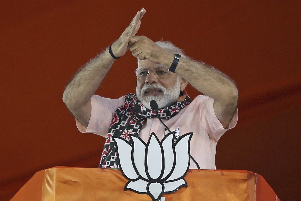 Indian Prime Minister Narendra Modi with the symbol of his Hindu-nationalist Bharatiya Janata Party. Photo: AP