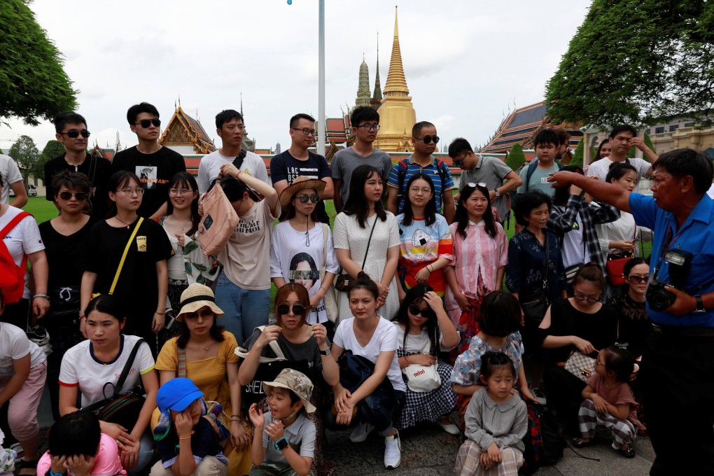 Chinese tourists outside the Temple of the Emerald Buddha in Bangkok. Photo: Reuters
