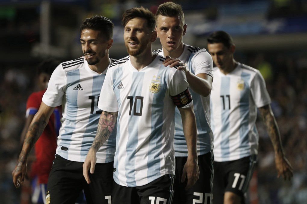 New Tottenham Hotspur signing Giovanni Lo Celso holds on to Argentina teammate Lionel Messi. Photo: AP