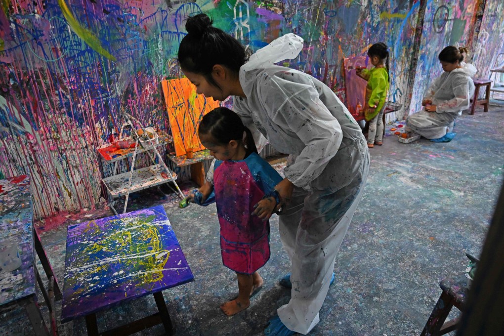 Singaporeans can unwind from the stresses of daily life by getting messy and creative with paint at Splat Paint House in Singapore. Photo: Roslan Rahman/AFP