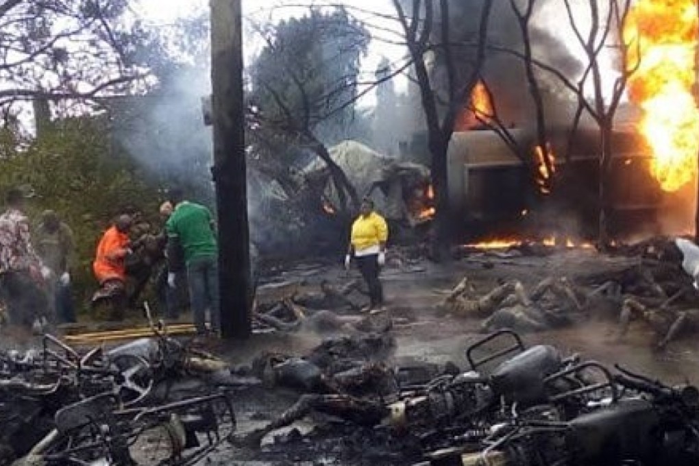 People were trying to siphon away fuel when the tanker burst into flames. Photo: Twitter