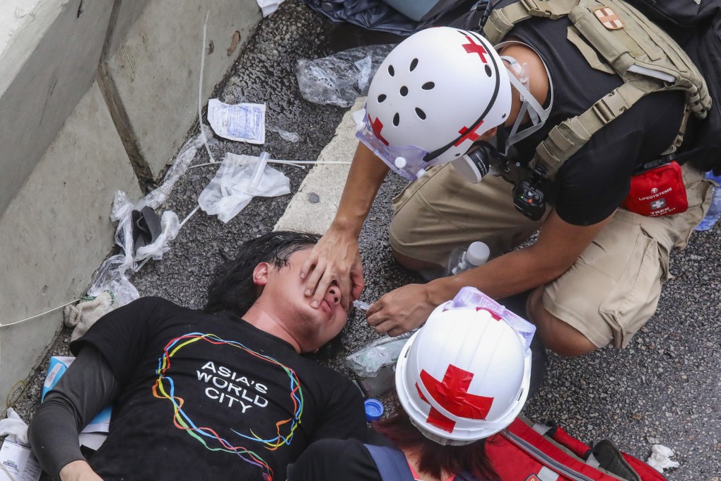 An injured protester is treated after clashing with police on July 1, 2019. Photo: K. Y. Cheng