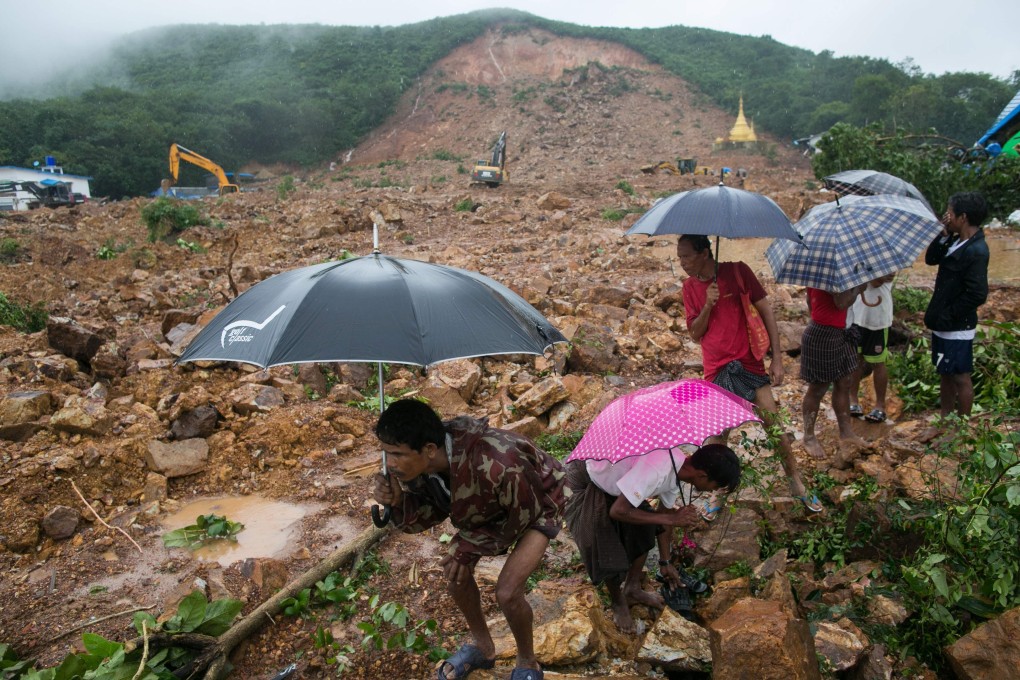 People watch rescue efforts after a landslide in Paung township in Myanmar. Photo: AFP