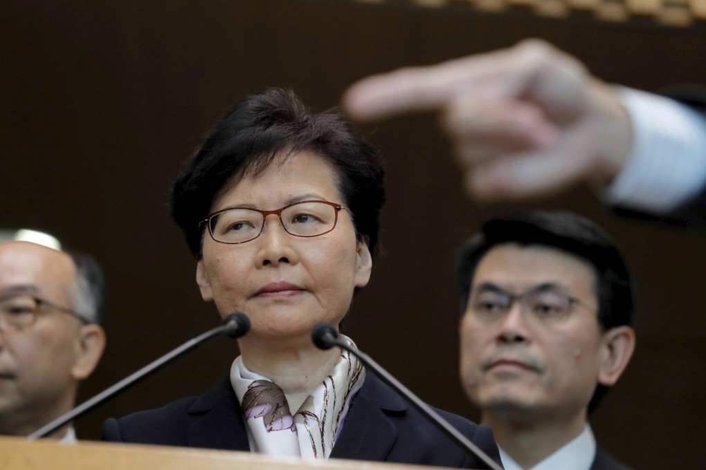 Hong Kong’s Chief Executive Carrie Lam, center, waits for questions during a press conference in Hong Kong on Monday. Photo: AP