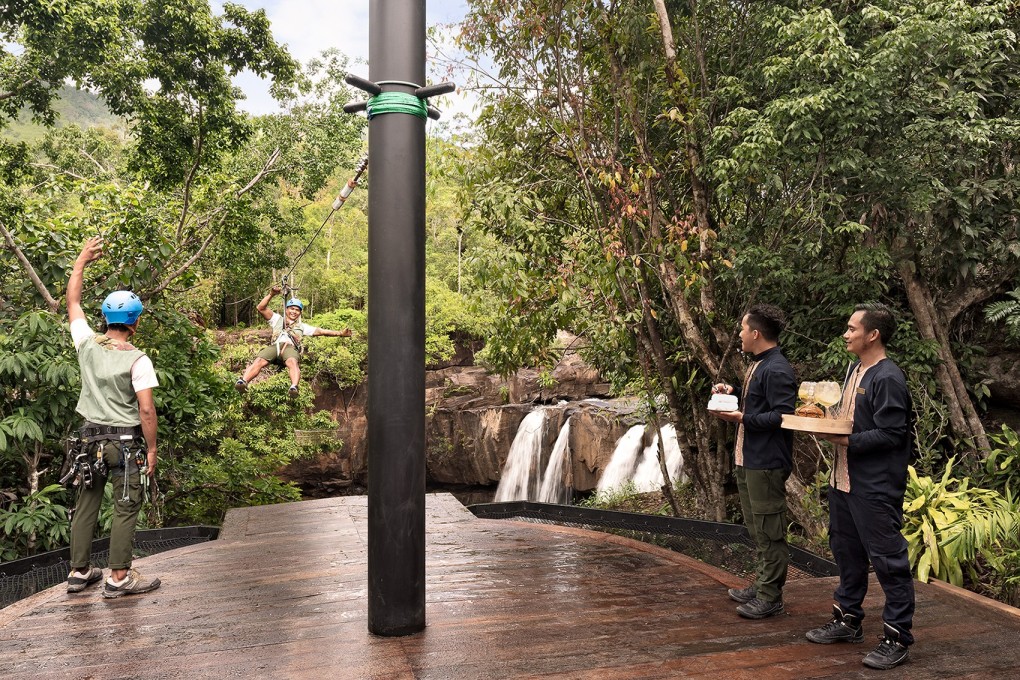 Hotel guests arriving by zip line at the Shinta Mani Wild conservation camp in Cambodia, part of US architect Bill Bensley’s hotel chain Bensley Collection.