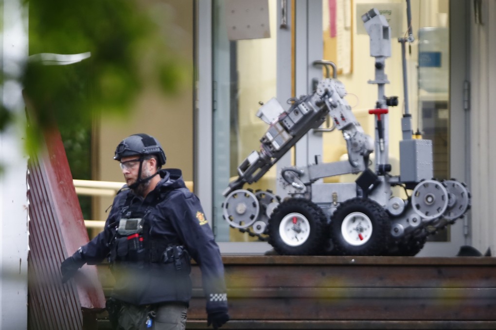 A police officer with a robot on a site of a shooting inside the al-Noor Islamic centre mosque in Baerum outside Oslo, Norway. Photo: EPA