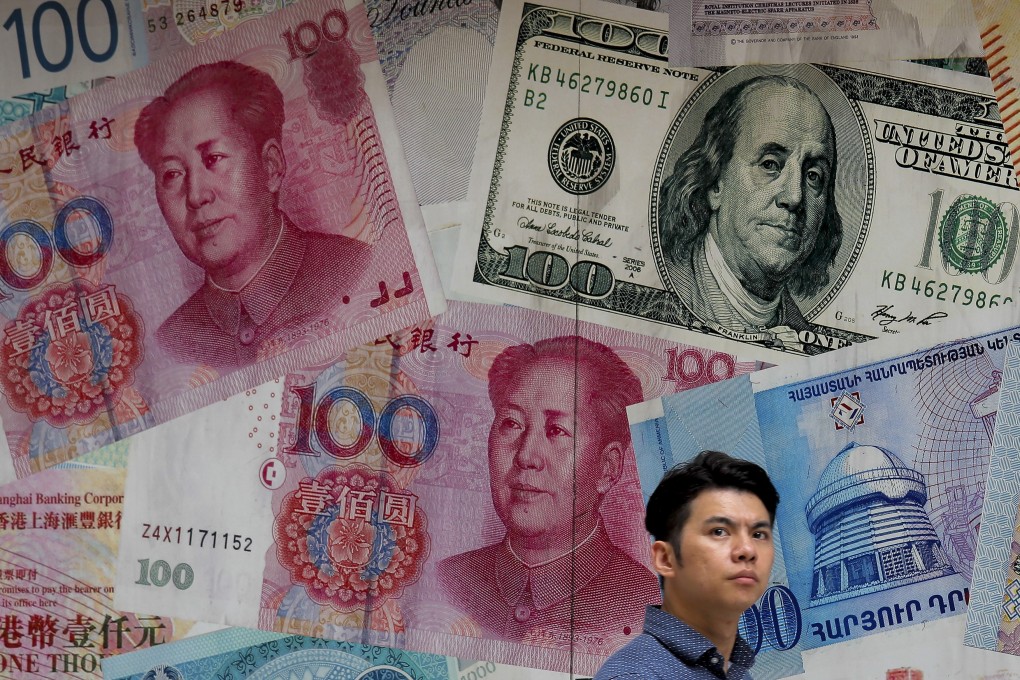 A man walks past a money exchange shop decorated with different banknotes at Central, a business district in Hong Kong. Photo: AP