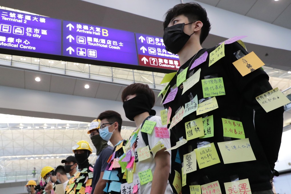 Extradition bill protesters take part in a sit-in at Hong Kong International Airport invite travellers to post messages on them on August 9. Photo: Edmond So