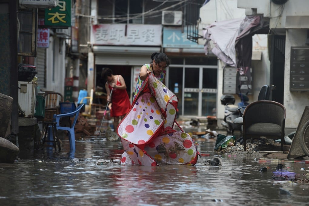 After Typhoon Lekima hit Linhai in Zhejiang province, residents began to rescue what belongings they could. Photo: Reuters