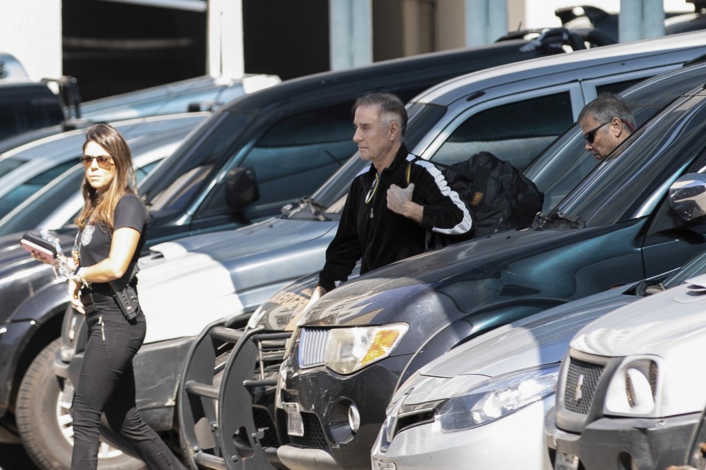 Brazilian businessman Eike Batista, centre, is escorted to a police station in Rio de Janeiro. Photo: AP Photo