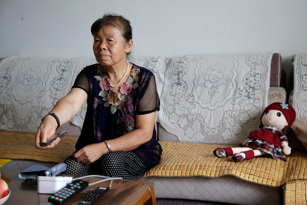 China tech firms are getting into the elderly care market. Bi Fenghua, 66, uses a TV remote control to perform the video chat function provided by Lanchuang Network Technology's elderly care system. Photo: Reuters/Jason Lee