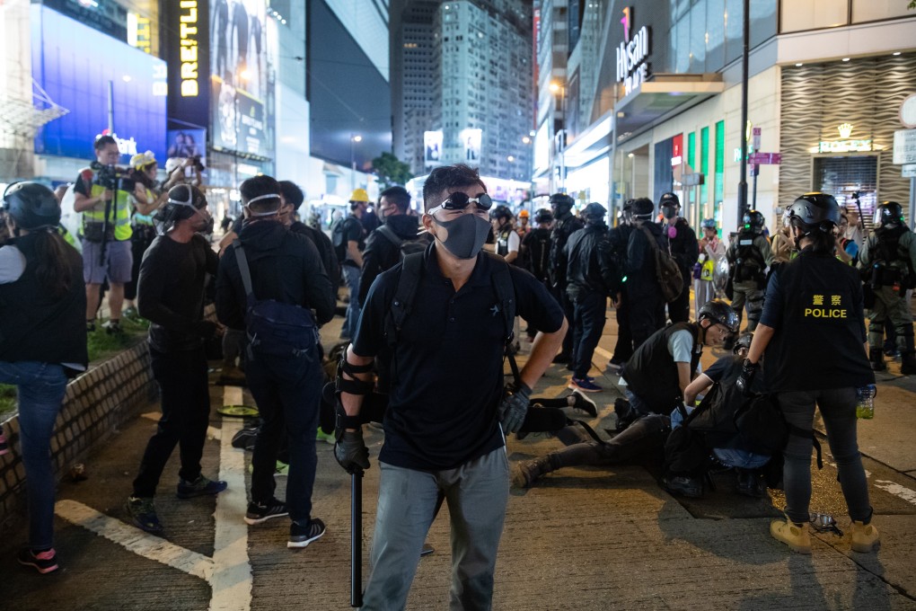 Men in black believed to be officers in Causeway Bay. Photo: Kyle Lam/Bloomberg
