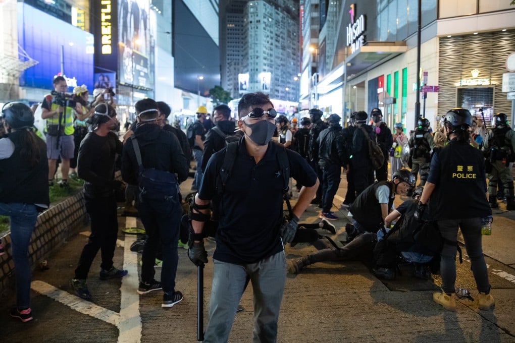 Men in black believed to be officers in Causeway Bay. Photo: Kyle Lam/Bloomberg