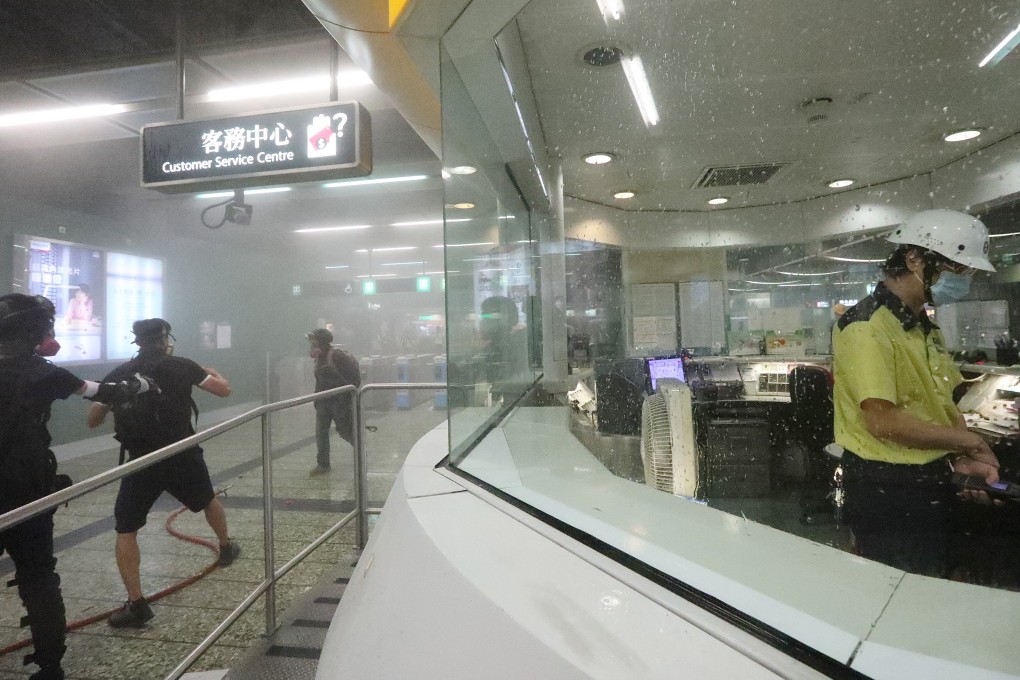 A staff member wearing a helmet and mask at Kwai Fong MTR station after police deployed tear gas in the station on Sunday night. Photo: Felix Wong