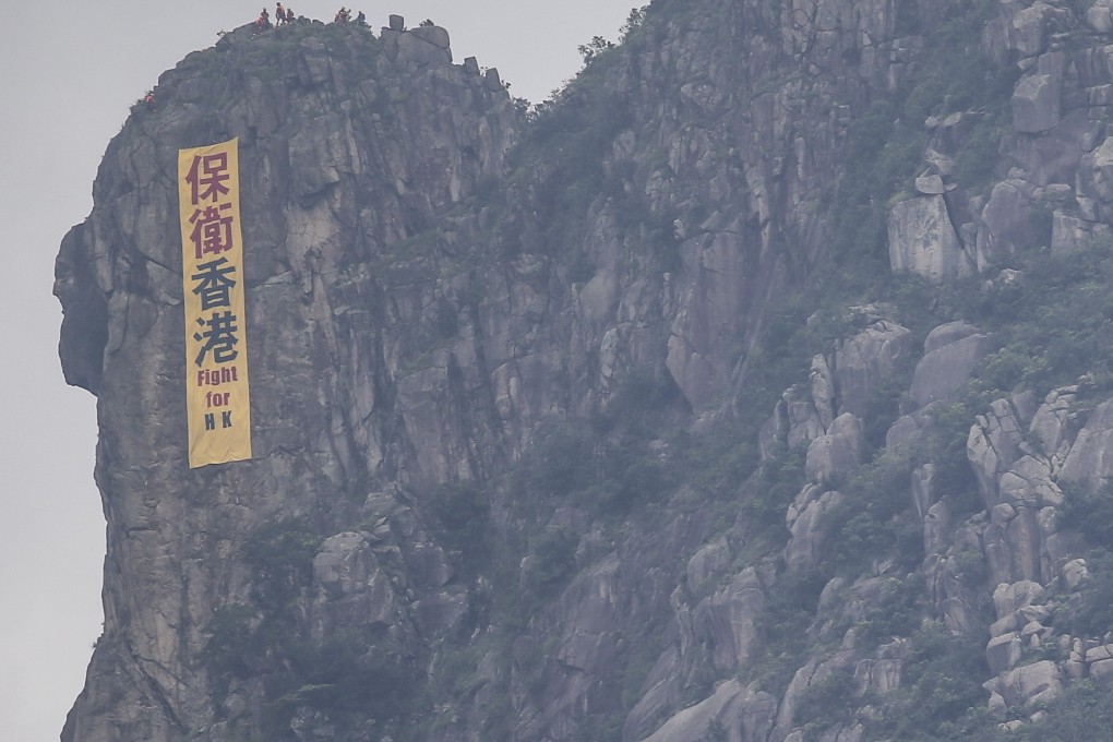 Fight for Hong Kong, says a banner seen hanging off Lion Rock in June. Photo: Winson Wong
