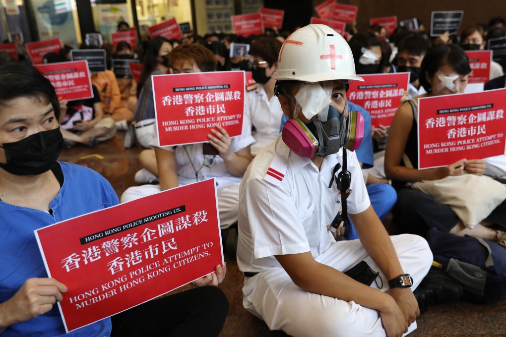 Health care staff stage a demonstration at Queen Elizabeth Hospital on Tuesday to protest against alleged use of force by police on anti-government protesters. Photo: Nora Tam