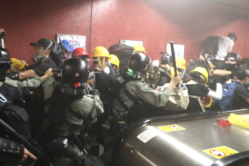 Riot Police charge at protesters on a moving escalator at Tai Koo station on Sunday night. Photo: Handout