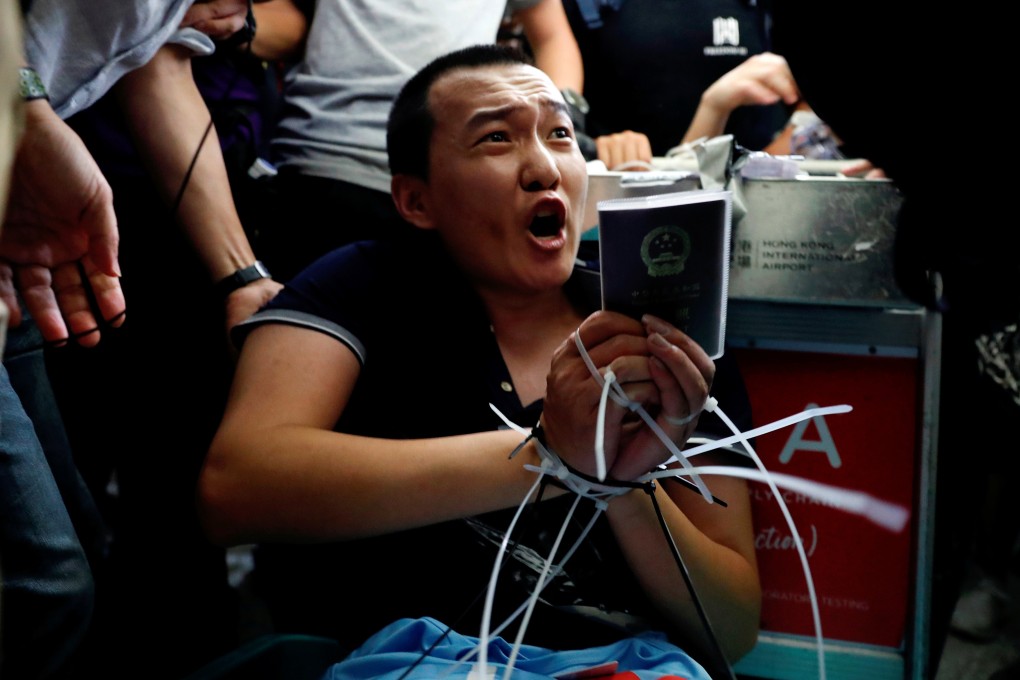 Fu Guohao, a journalist for the nationalist Global Times, was tied up and beaten by protesters at Hong Kong airport. Photo: Reuters