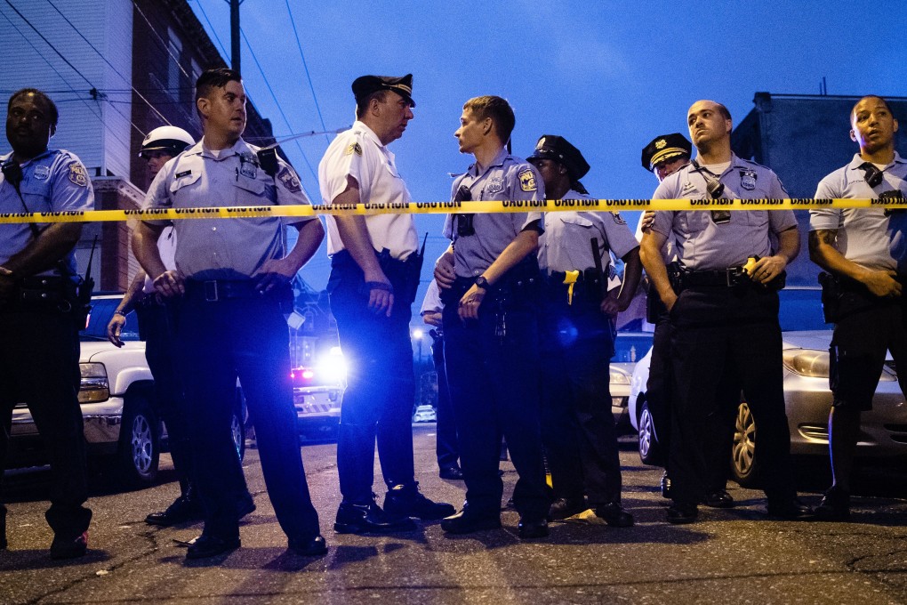 Officers gather at the scene of a shooting in Philadelphia. Photo: AP
