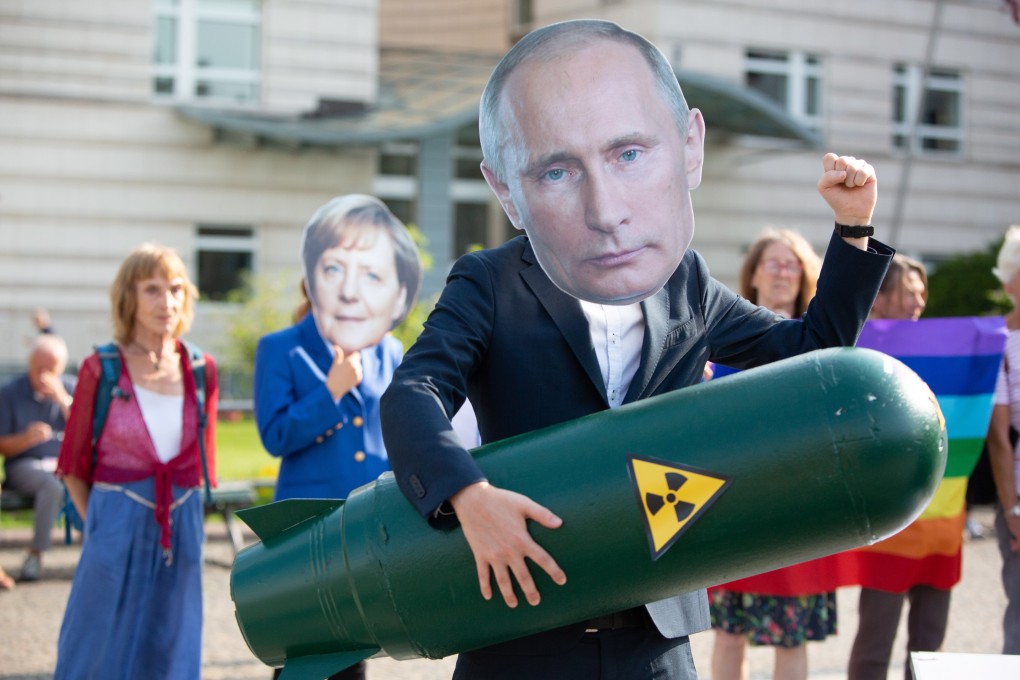 An activist wears a mask of Russian President Vladimir Putin and holds a mock missile during a demonstration against the termination of the Intermediate-Range Nuclear Forces Treaty, in front of the US embassy in Berlin. Photo: EPA-EFE