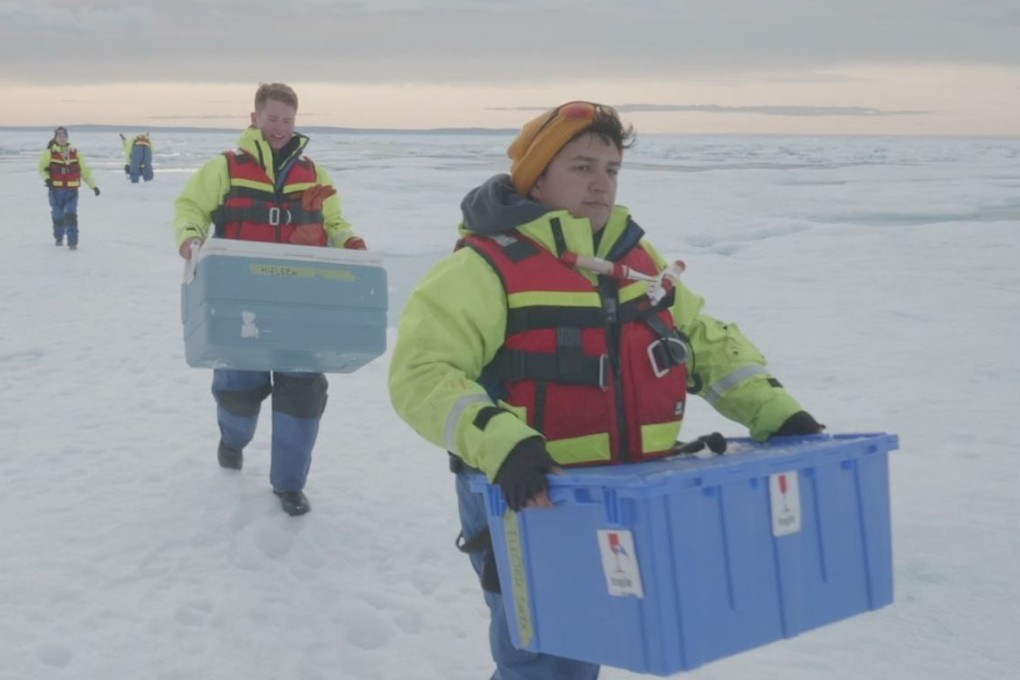 Scientists carry boxes of ice cores drilled from the Canadian Arctic. Photo: Reuters