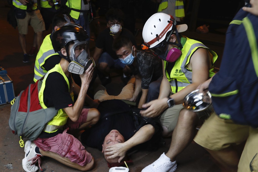 A protester is overcome by tear gas near the Sham Shui Po police station in Hong Kong on Wednesday. Photo: AP