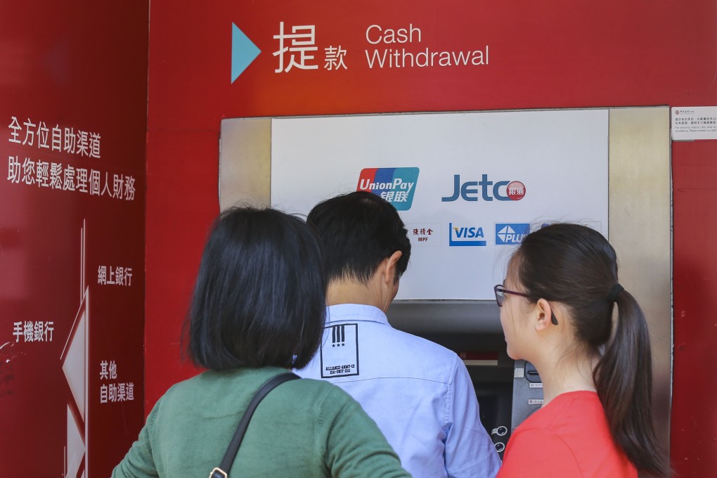 Customers using a Bank of China (Hong Kong) automated teller machine in Hong Kong on 31 March 2018. Photo: SCMP / Dickson Lee