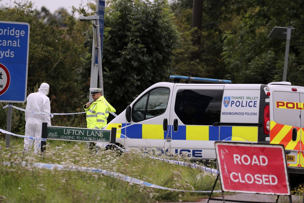 An investigator at the scene of an incident where a police officer was killed in Britain. Photo: AP