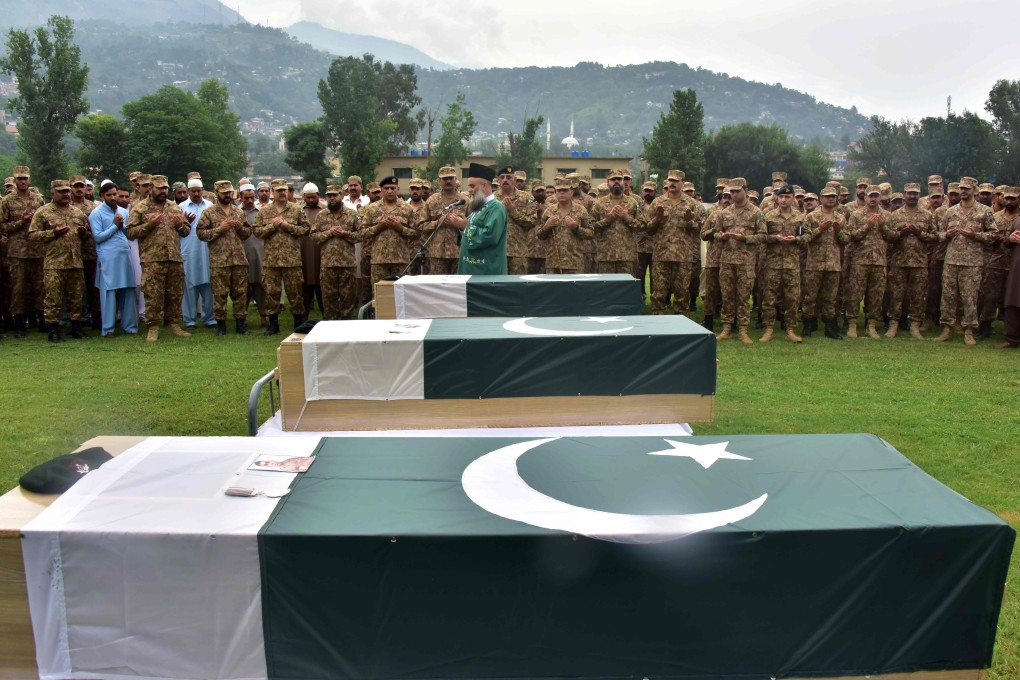 Pakistani army officials and soldiers pray beside coffins holding the bodies of three colleagues killed in cross-border shelling during a funeral in Muzaffarabad, the capital of Pakistan-controlled Kashmir, on Friday. Photo: AFP