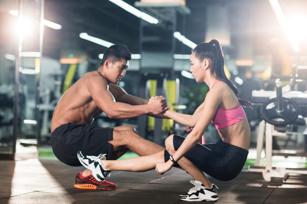 Young Chinese couple exercising at gym - smart materials and wearable tech are popular in the sports industry. Photo: Alamy