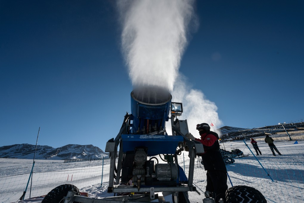 A technician checks a cannon spraying artificial snow at El Colorado ski centre in the Andes Mountains. Photo: AFP