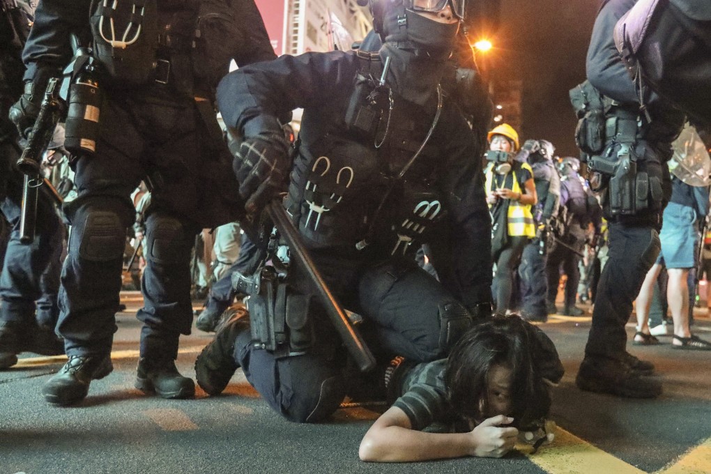 A member of the police special tactical squad subdues an extradition bill protester in Mong Kok on August 3. Photo: Felix Wong