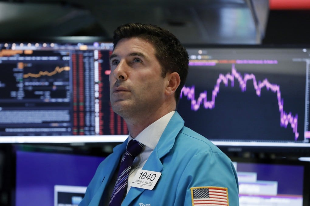 Trader Thomas McArdle works on the floor of the New York Stock Exchange on Wednesday. The Dow Jones Industrial Average sank 800 points after the bond market flashed a warning sign about a possible recession for the first time since 2007. Photo: AP