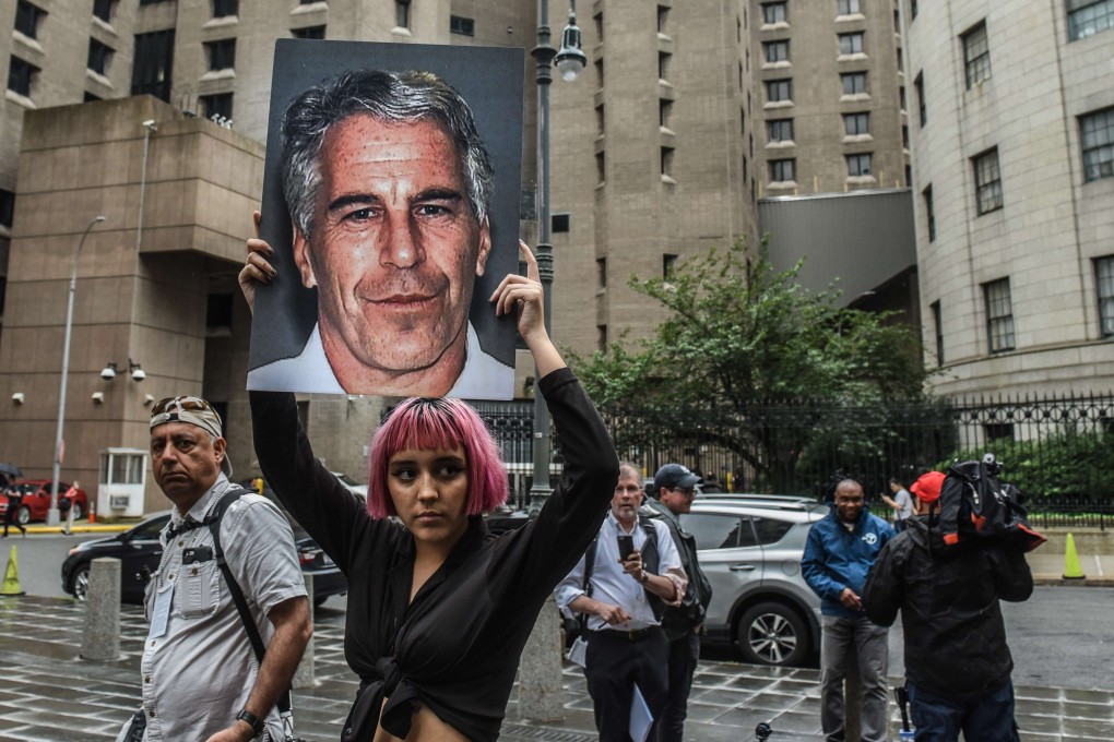 A protester holds up a picture of Jeffrey Epstein in front of the Metropolitan Correction Centre in July. Photo: AFP
