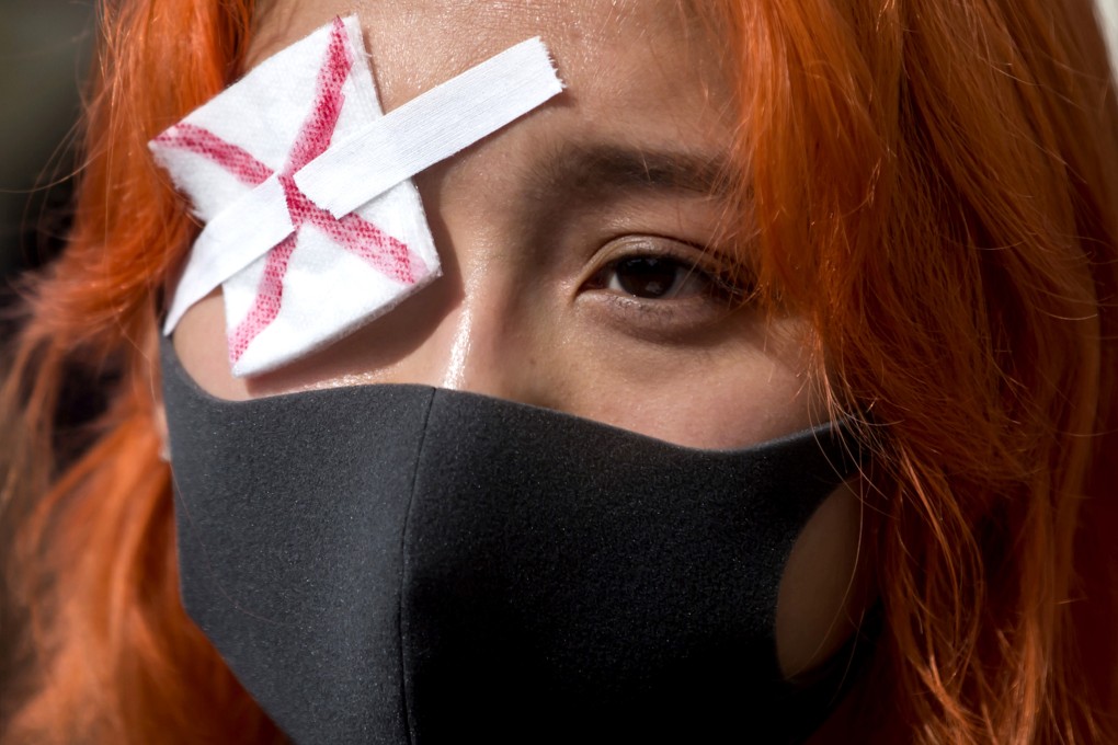 A Hong Kong anti-extradition bill protester attends a rally as pro-China counterprotesters also gather nearby, in Vancouver, Canada. Photo: AP